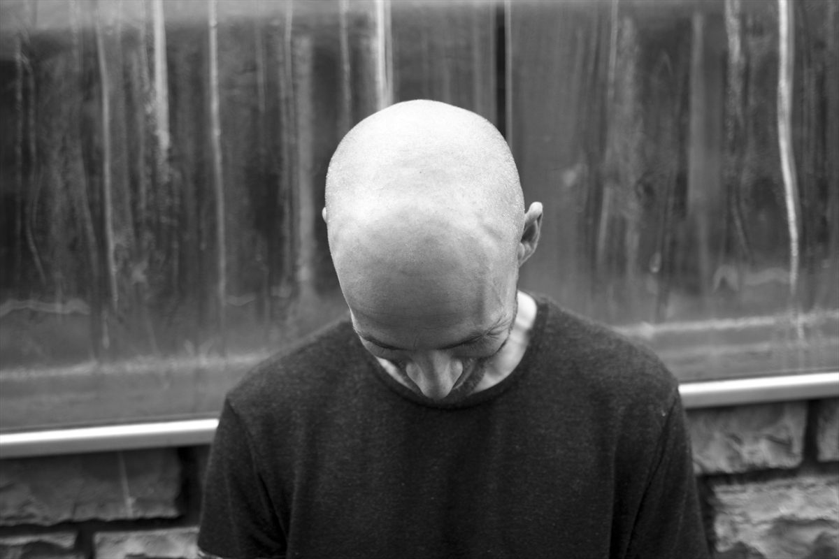 Youri Donatz with his head bowed, black and white