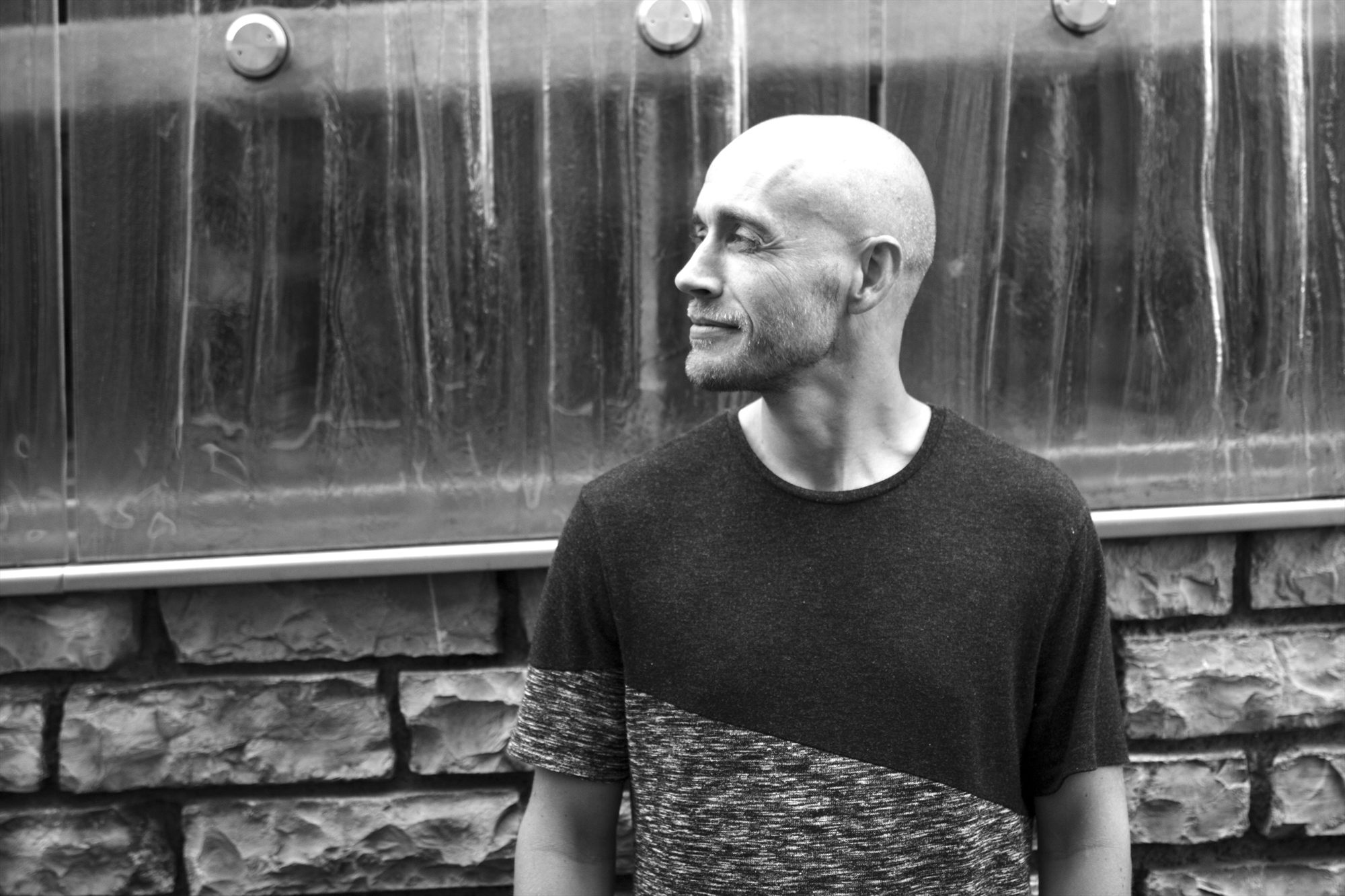 Youri Donatz, black and white portrait against a glass wall